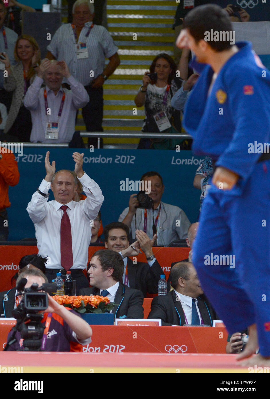 Russian President Vladimir Putin applauds gold medalist Tagir Khaibulaev of Russia at the Judo venue at the ExCel center at the London 2012 Summer Olympics on August 2, 2012 in London.  The Russians took gold in Men's 100kg. UPI/Terry Schmitt Stock Photo