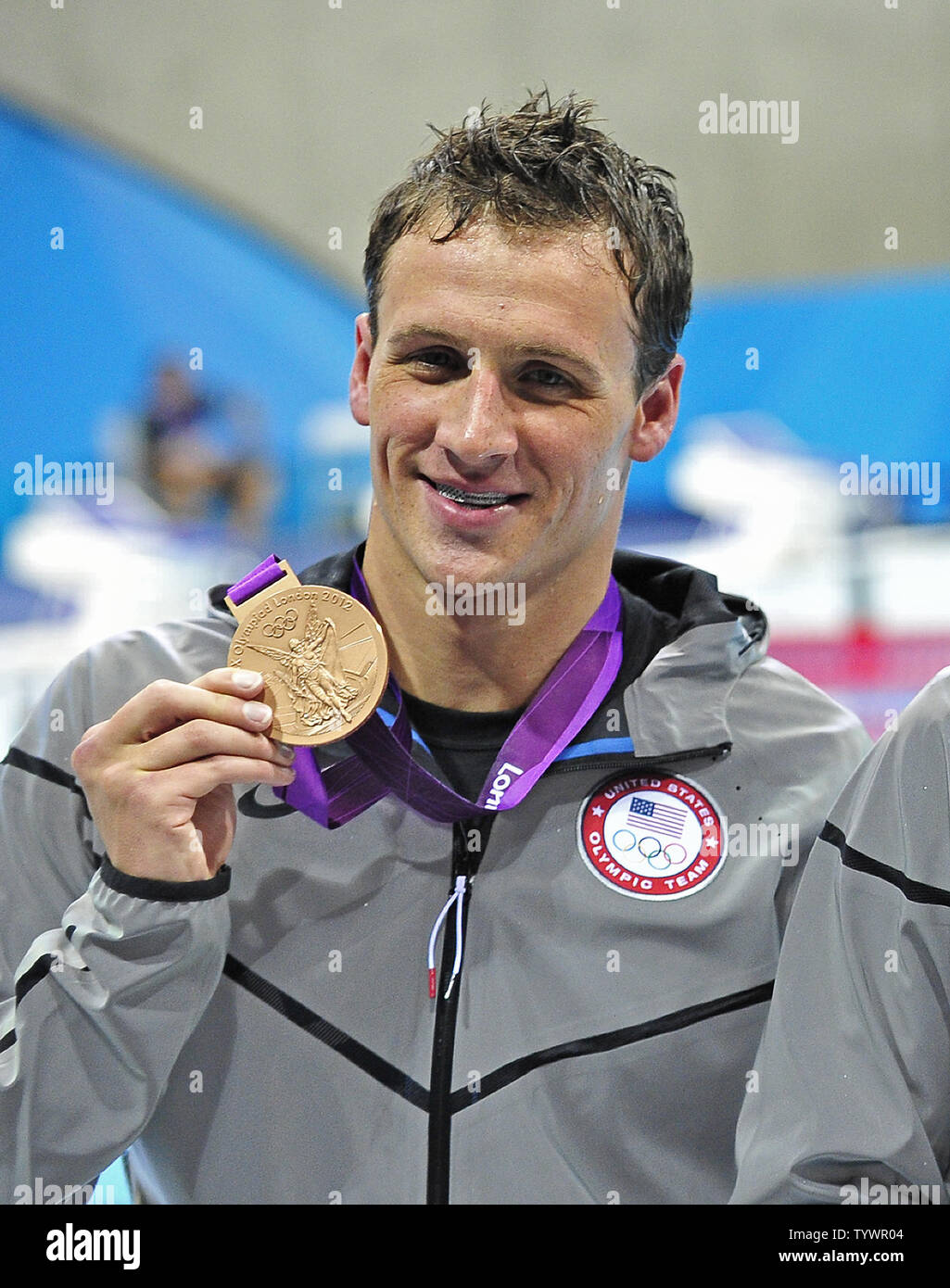 Ryan Lochte of the United States shows off the Bronze Medal he won in the Men's 200m Backstroke Finals with a time of 1:53.94 at the London 2012 Summer Olympics on August 2, 2012 in London.  Lochte won two medals on the night.  The other was a Silver Medal with a time of 1:54.90 in the Men's 200m Individual Medley Final. UPI/Ron Sachs Stock Photo