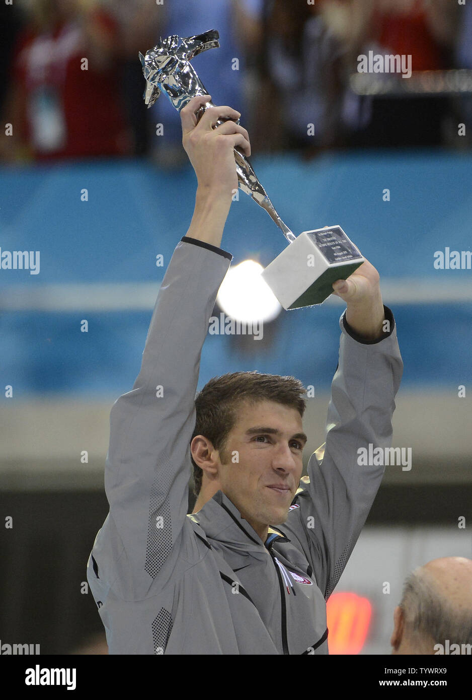Michael Phelps Of The United States Holds A Trophy For The Most