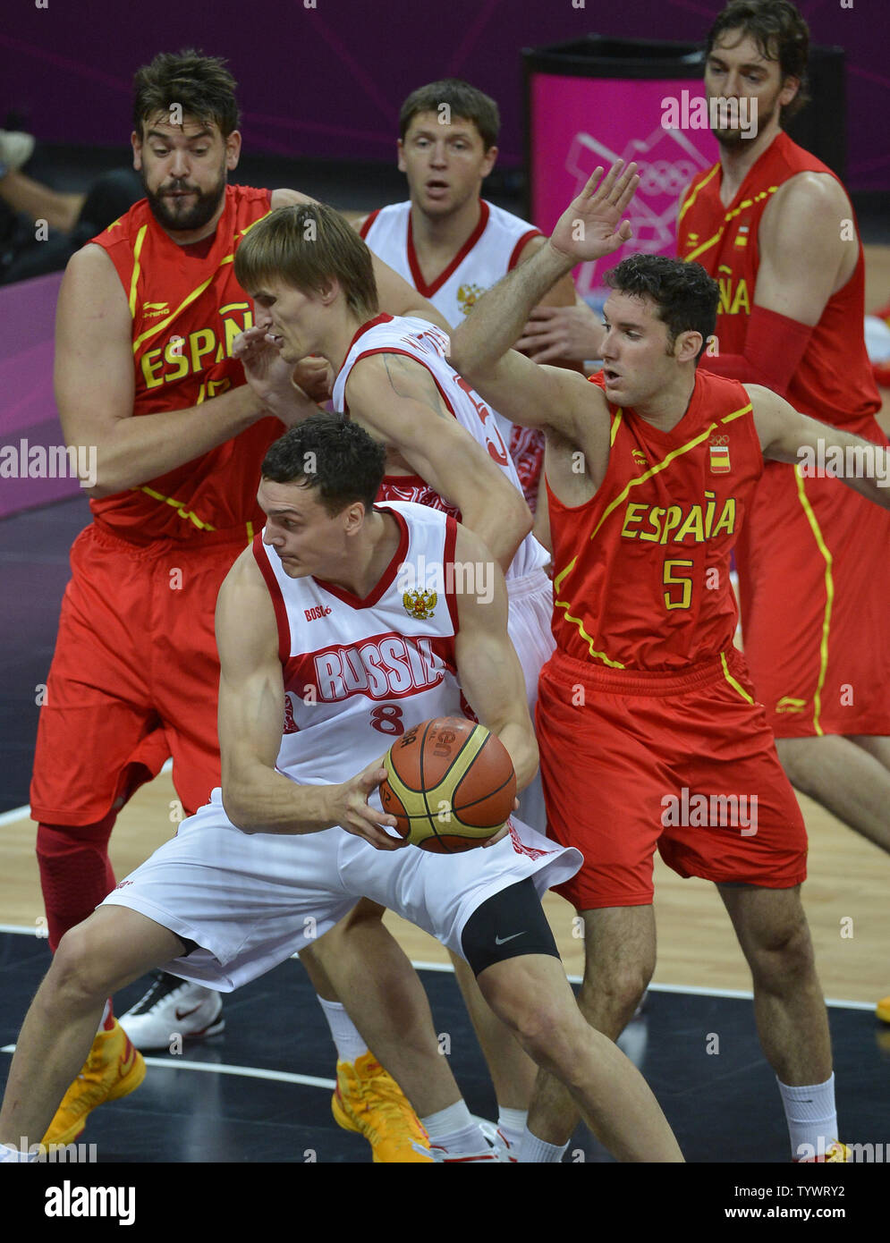 Russia's Sasha Kaun (C) looks to move the ball against Spain's Rudy Fernandez (R) and Marc Gasol (L) during the Spain-Russia Men's Basketball Preliminary competition at the 2012 Summer Olympics, August 4, 2012, in London, England.             UPI/Mike Theiler Stock Photo