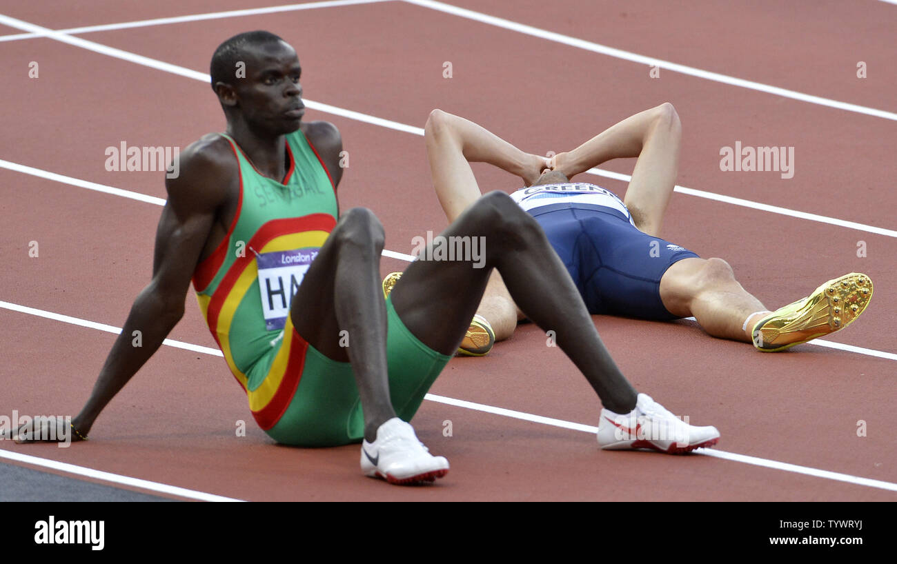 Great Britain's David Greene covers his face in disbelief as he lies on the track after finishing his Men's 400m Hurdles semifinal in fourth place and failing to qualify for the final  at the 2012 Summer Olympics, August 4, 2012, in London, England. Senegal's Mamadou Kasse Hanne is at (L).            UPI/Mike Theiler Stock Photo