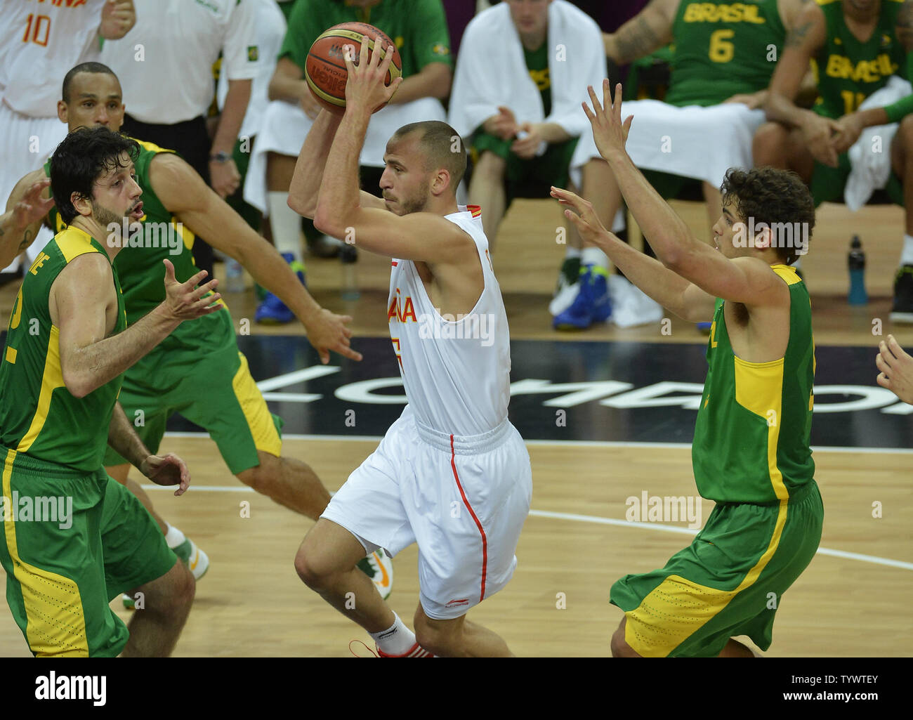 Spain's Sergio Rodriguez (C) drives to the basket as he is defended against by Brazil's Guilherme Giovannoni (L) and Raul Neto, during the Brazil-Spain Men's Basketball Preliminary competition at the 2012 Summer Olympics, August 6, 2012, in London, England.             UPI/Mike Theiler Stock Photo