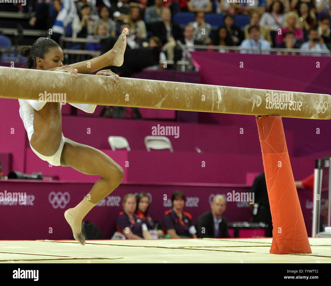 American gymnast Gabrielle Douglas slips and has to grasp the balance beam  as she fell during her routine at the Apparatus Finals at the Greenwich  North Arena at the 2012 Summer Olympics,