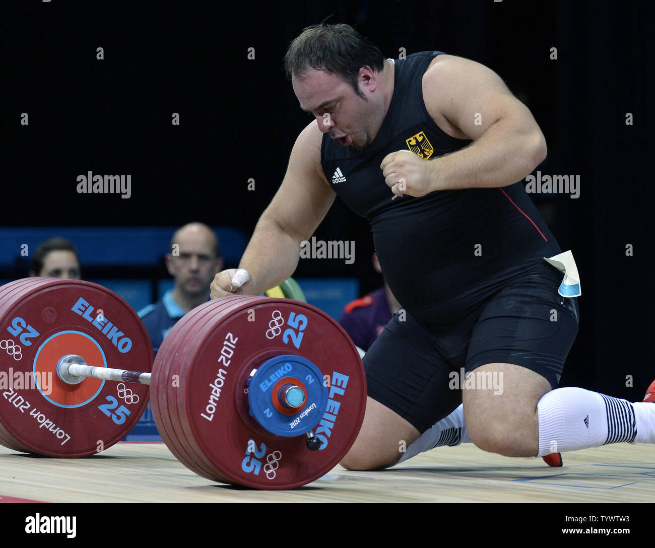 German weightlifter Almir Velagic drops to the floor in jubilation after he makes a successful lift during the Men's 105kg+ Group A class, at the Excel Arena at the 2012 Summer Olympics, August 7, 2012, in London, England.              UPI/Mike Theiler Stock Photo