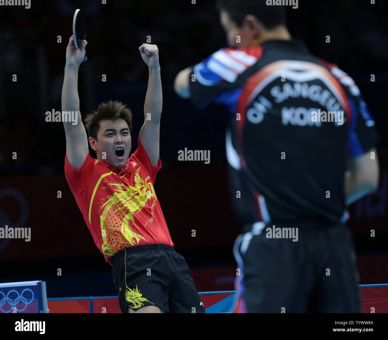 China's Hao Wang celebrates victory over South Korea in the team final ...