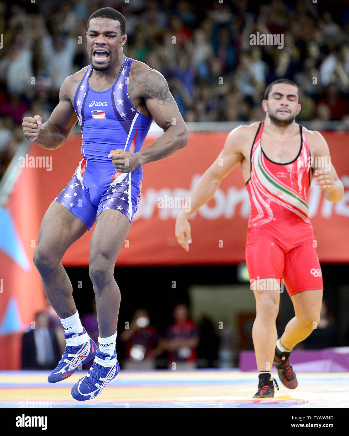 Jordan Ernest Burroughs of the United States of America, left, celebrates after winning the Gold Medal in the Men's 74kg Freestyle Wrestling against Sadegh Saeed Goudarzi of Iran, right, at the London 2012 Summer Olympics on August 10, 2012 in London. UPI/Ron Sachs Stock Photo