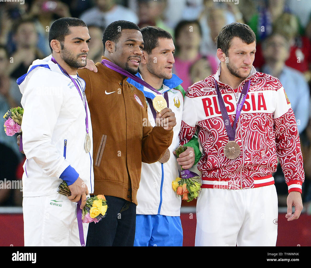 Medalists in the Men's 74kg Freestyle Wrestling show off their hardware at the London 2012 Summer Olympics on August 10, 2012 in London.  From left to right: Sadegh Saeed Goudarzi of Iran, Silver Medal; Jordan Ernest Burroughs of the United States of America, Gold Medal; Soslan Tigiev of Uzbekistan; and Denis Tsargush of Russia, Bronze Medal.UPI/Ron Sachs Stock Photo