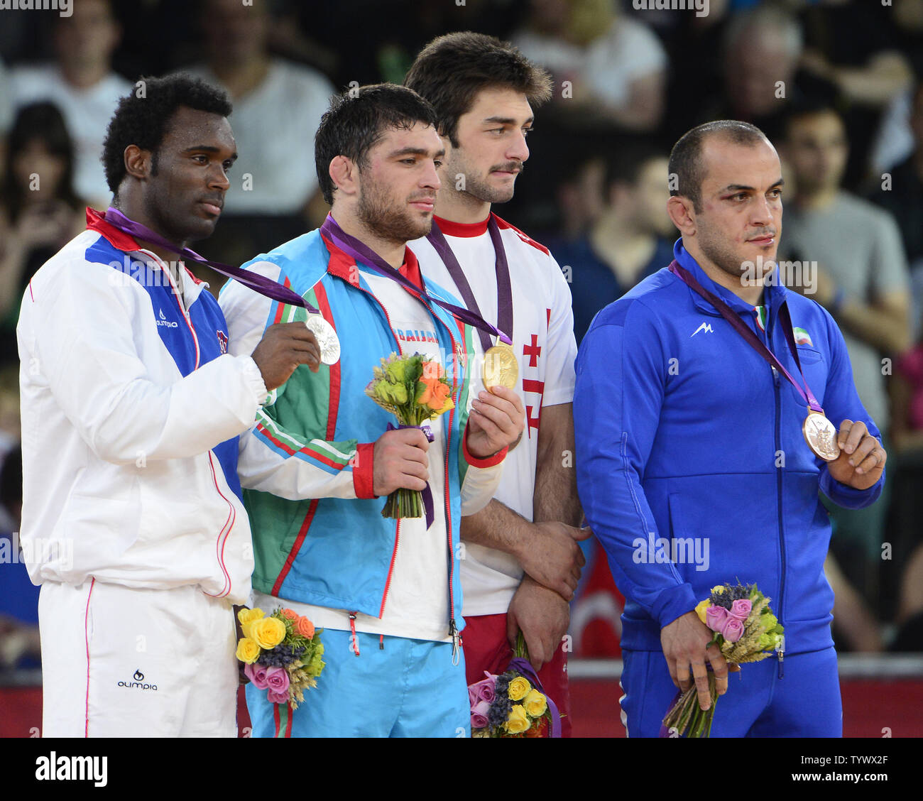 Medalists in the Men's 84kg Freestyle Wrestling show off their new hardware at the London 2012 Summer Olympics on August 10, 2012 in London. From left to right: Jaime Yusept Espinal of Puerto Rico, Silver Medal; Sharif Sharifov of Azerbaijan, Gold Medal; Dato Marsagishvili of Georgia, Bronze Medal; and Ehsan Naser Lashgari of Iran, Bronze Medal.  UPI/Ron Sachs Stock Photo