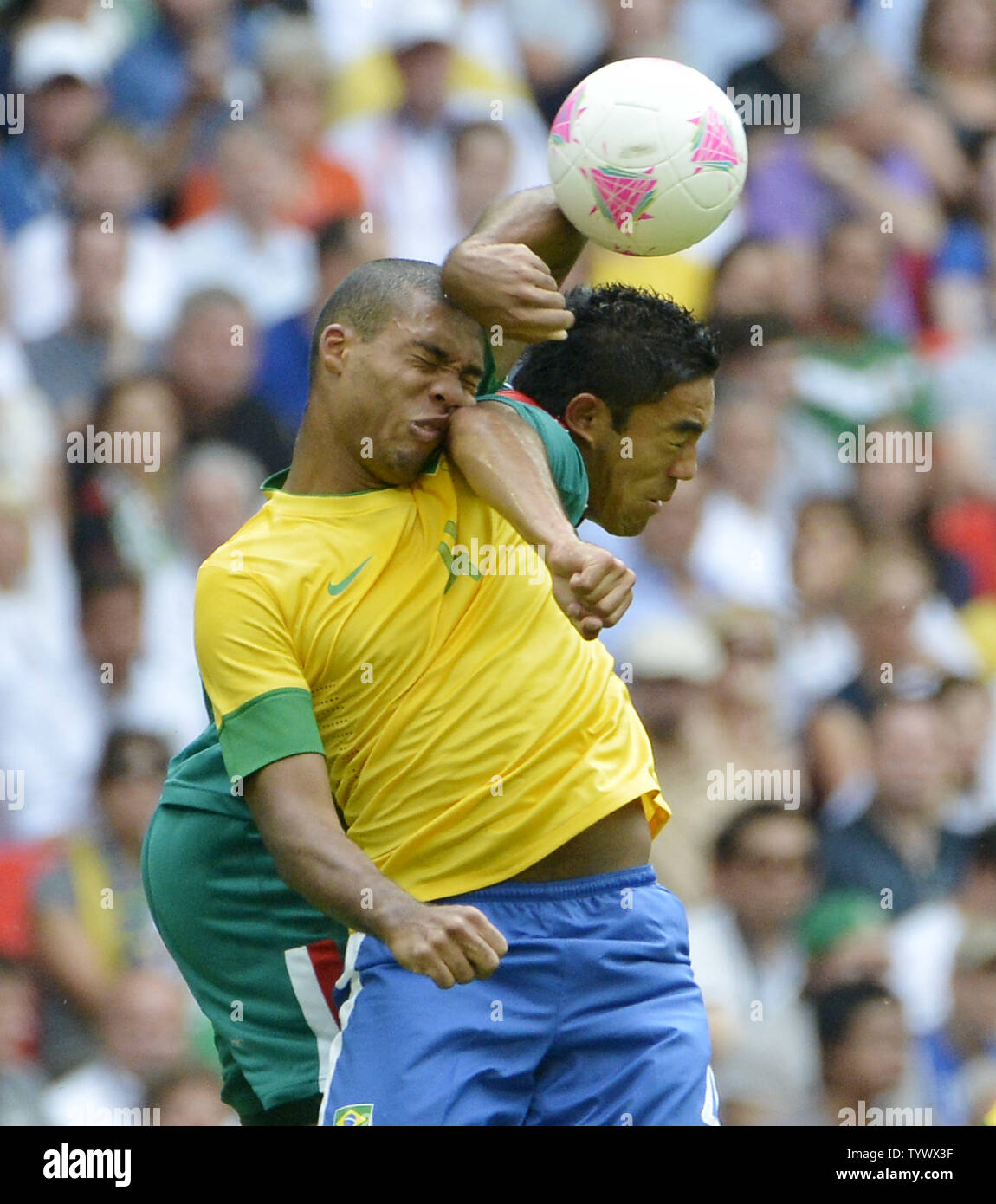 Defender Juan Jesus of Brazil (L) and forward Marco Fabian of Mexico go for the ball during the first half of the Gold Medal Football Match at the London 2012 Summer Olympics on August 11, 2012 at Wembley Stadium, London.      UPI/Brian Kersey Stock Photo
