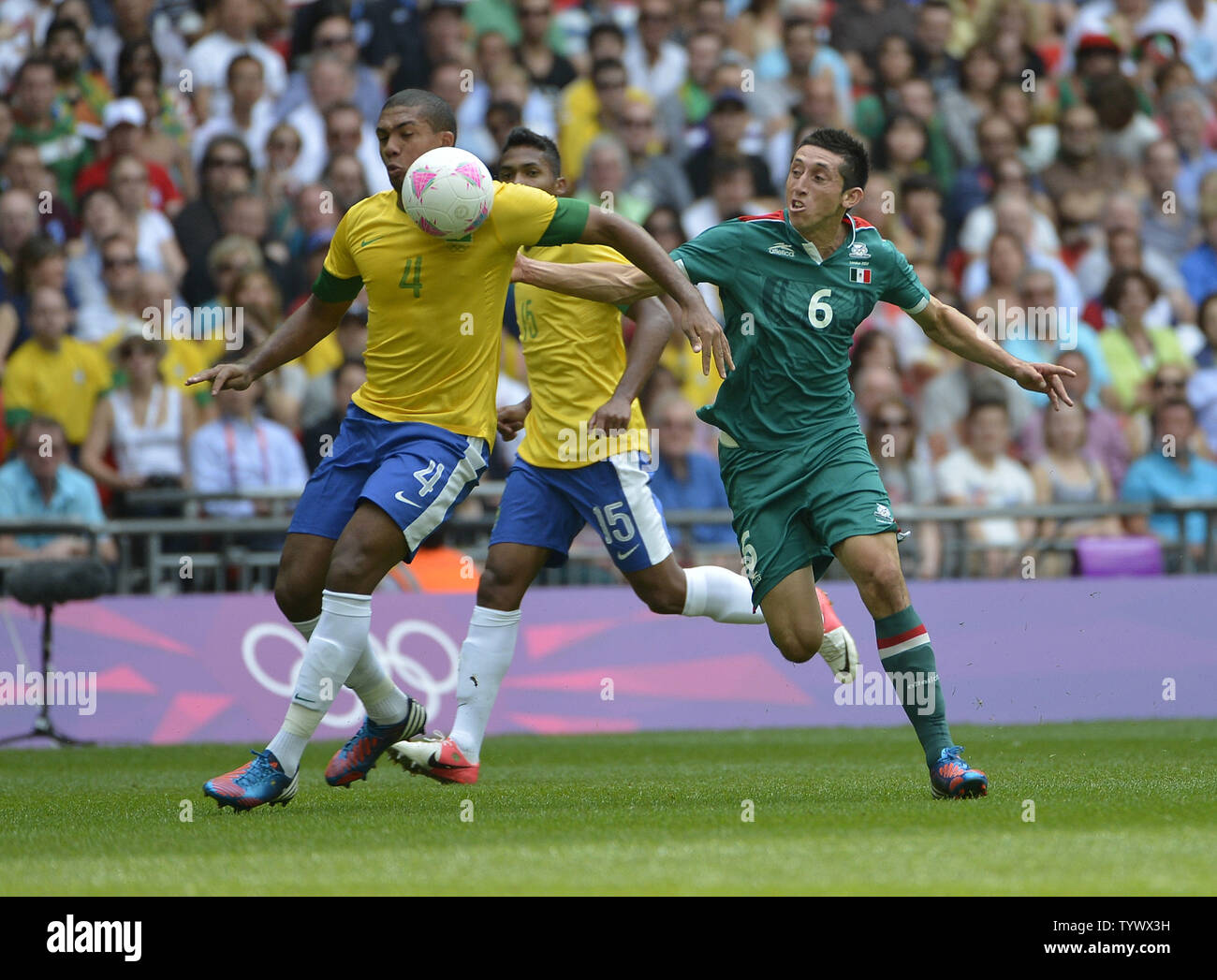 Defender Juan Jesus of Brazil (L) and midfielder Hector Herrera of Mexico go for the ball during the first half of the Gold Medal Football Match at the London 2012 Summer Olympics on August 11, 2012 at Wembley Stadium, London.      UPI/Brian Kersey Stock Photo