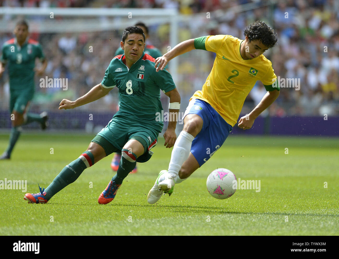 Forward Marco Fabian of Mexico and defender Rafael of Brazil go for the ball  during the first half of the Gold Medal Football Match at the London 2012 Summer Olympics on August 11, 2012 at Wembley Stadium, London.      UPI/Brian Kersey Stock Photo