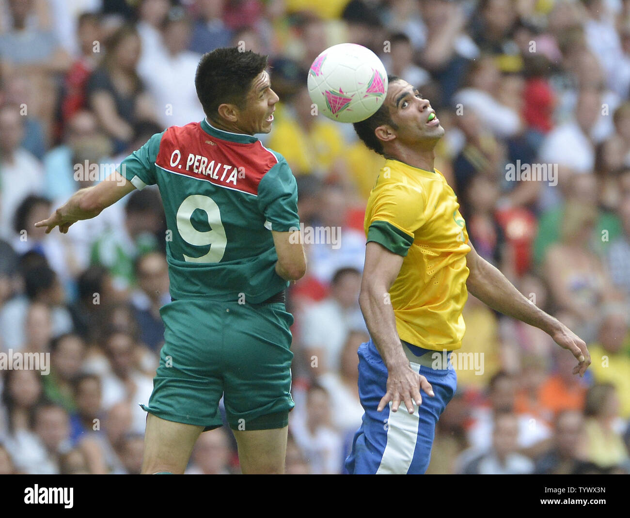 forward Oribe Peralta of Mexico and midfielder Sandro of Brazil go for the ball during the first half of the Gold Medal Football Match at the London 2012 Summer Olympics on August 11, 2012 at Wembley Stadium, London.      UPI/Brian Kersey Stock Photo