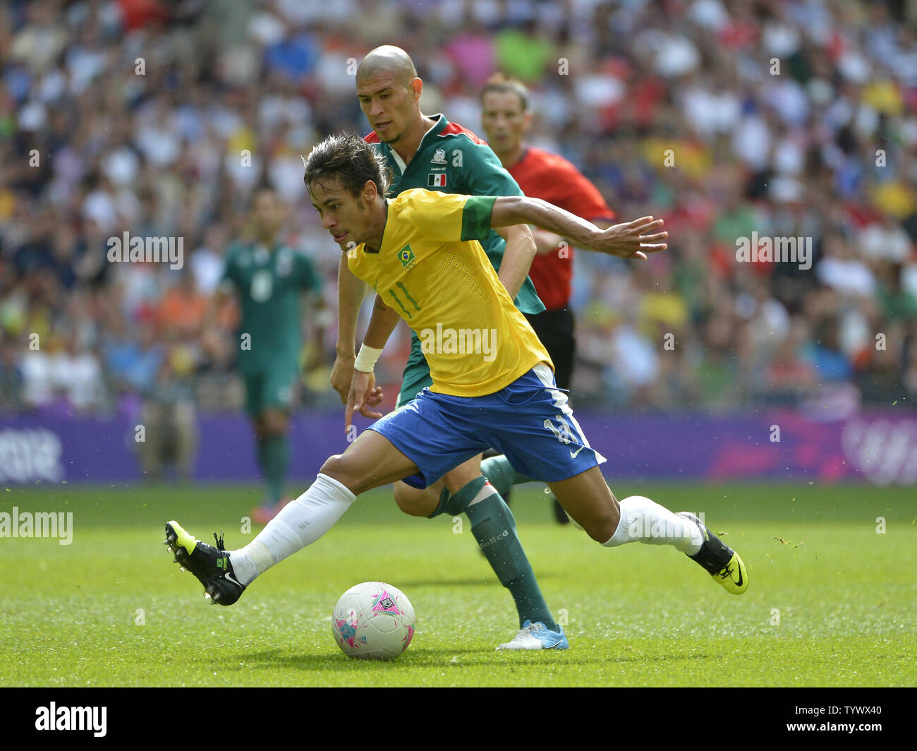 Forward Neymar of Brazil (L) moves the ball as midfielder Jorge Enriquez of Mexico defends during the second half of the Gold Medal Football Match at the London 2012 Summer Olympics on August 11, 2012 at Wembley Stadium, London. Mexico defeated Brazil 2-1 to win the Gold Medal.      UPI/Brian Kersey Stock Photo