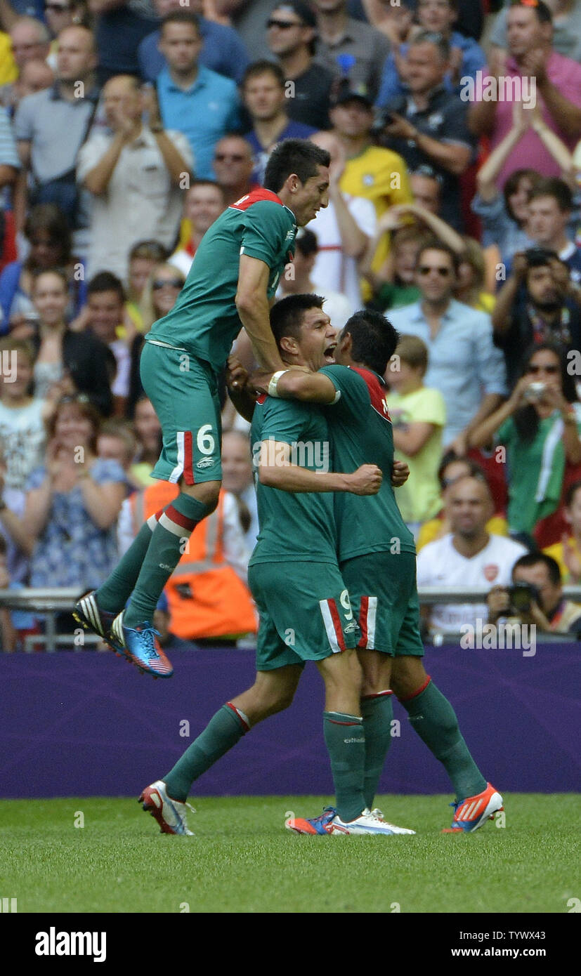 Midfielder Hector Herrera (L-R), forward Oribe Peralta  and forward Marco Fabian of Mexico celebrate Peralta's second goal of the match during the second half of the Gold Medal Football Match at the London 2012 Summer Olympics on August 11, 2012 at Wembley Stadium, London. Mexico defeated Brazil 2-1 to win the Gold Medal.      UPI/Brian Kersey Stock Photo