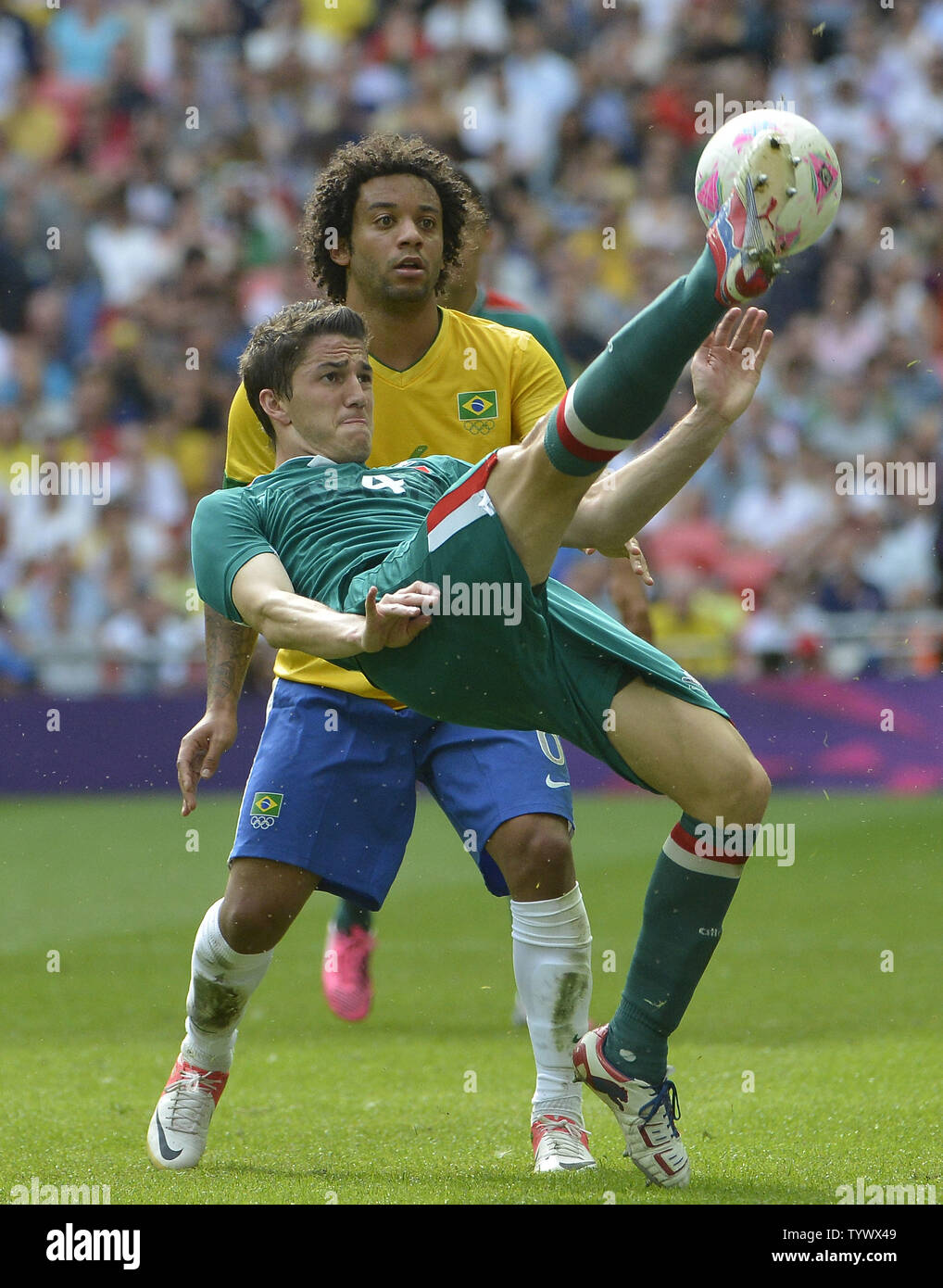 defender Hiram Mier of Mexico makes a bicycle kick as defender Marcelo of Brazil watches during the second half of the Gold Medal Football Match at the London 2012 Summer Olympics on August 11, 2012 at Wembley Stadium, London. Mexico defeated Brazil 2-1 to win the Gold Medal.      UPI/Brian Kersey Stock Photo