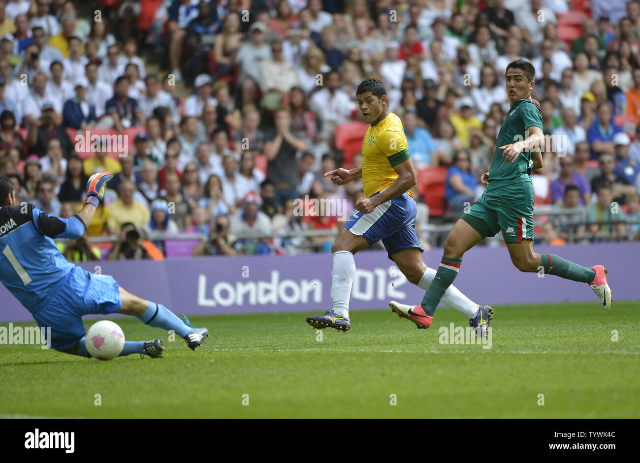 Forward Hulk of Brazil (C) scores past goalkeeper Jose Corona of Mexico (L) as defender Darvin Chavez of Mexico defends during the second half of the Gold Medal Football Match at the London 2012 Summer Olympics on August 11, 2012 at Wembley Stadium, London. Mexico defeated Brazil 2-1 to win the Gold Medal.      UPI/Brian Kersey Stock Photo