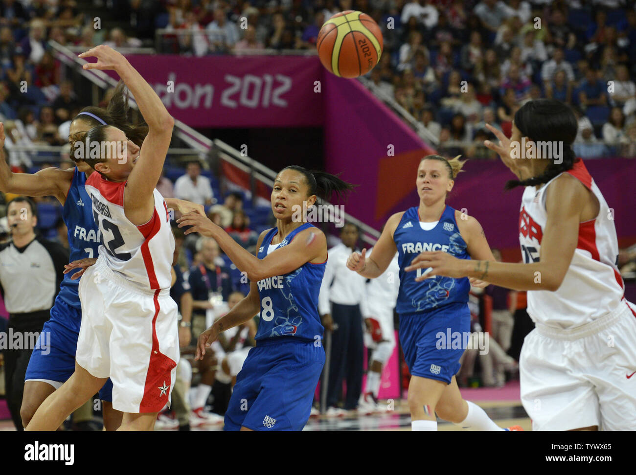 United States' Sue Bird (R) looks to pass the ball as she is defended by  France's Emmeline Ndongue during the USA-France Women's Basketball Gold  Medal Game at the 2012 Summer Olympics, August