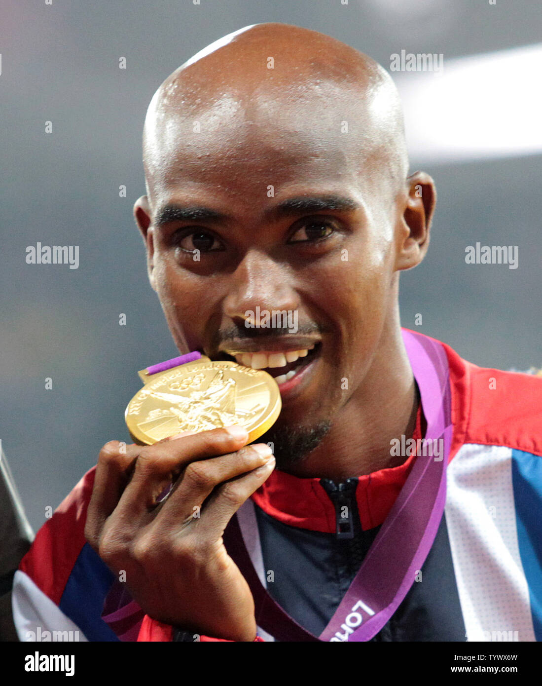 Great Britain's Mo Farah bites his gold medal after winning the Men's 5000 metres final on the ninth day of the Athletics in the Olympics stadium at the London 2012 Summer Olympics on August 11, 2012 in  London.     UPI/Hugo Philpott Stock Photo