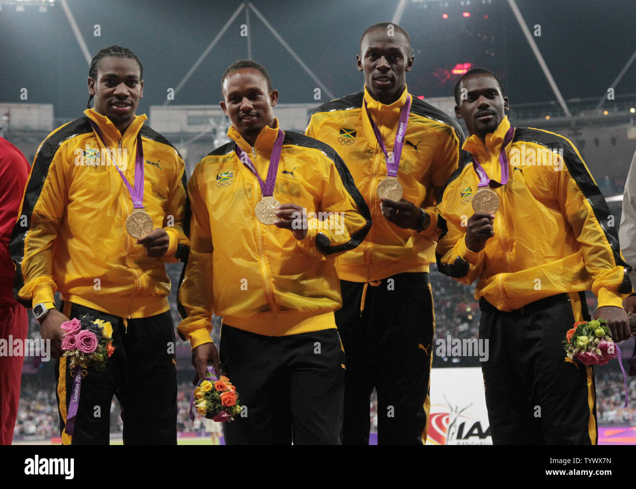 The Jamaican Men's 4x100 relay team hold their gold medals after