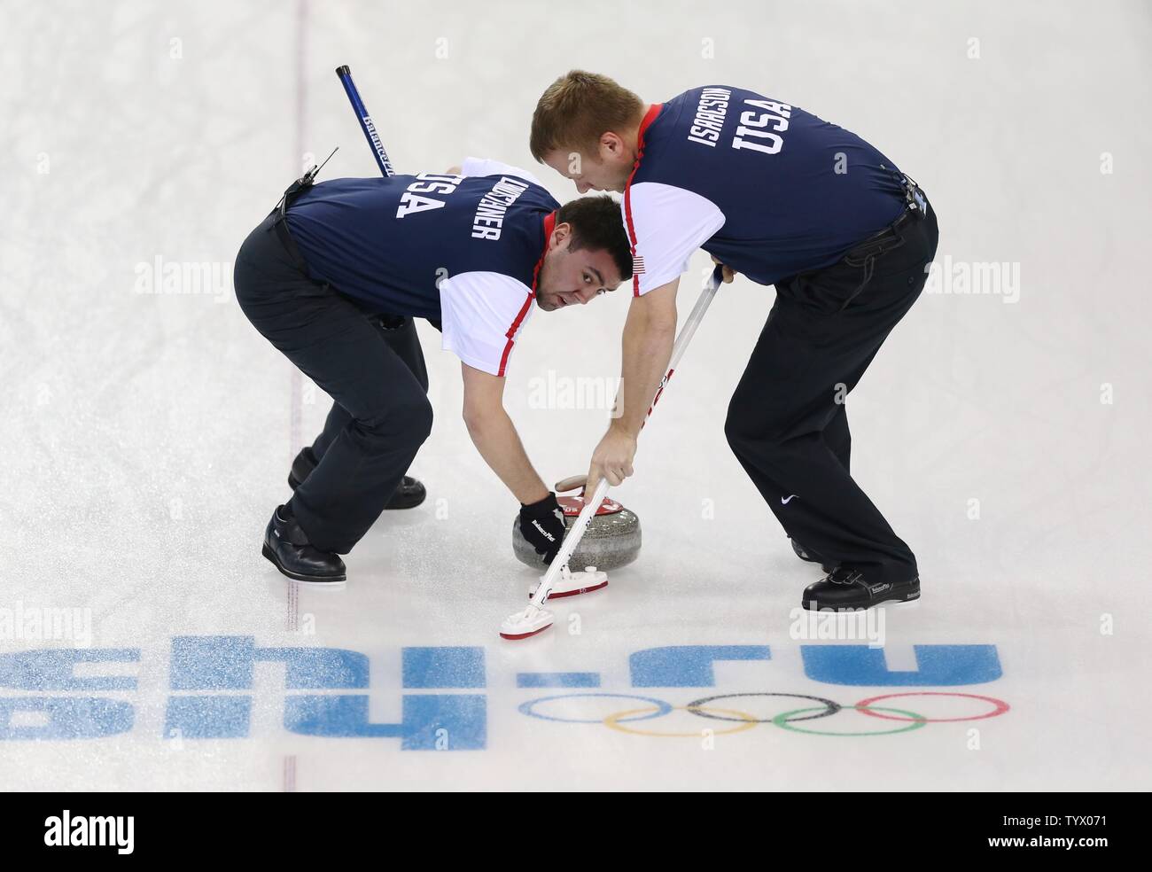 Americans Jeff Isaacson (right) and John Landsteiner sweep during their men's round robin session 2 curling against Norway during the Sochi 2014 Winter Olympics on February 10, 2014 in Sochi, Russia.   UPI/Molly Riley Stock Photo