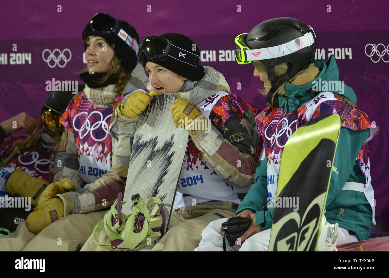 United States' Kelly Clark (C) awaits her score as she sits with teammate Kaitlyn Farrington (L) and Australia's Torah Bright during the ladies' snowboard halfpipe final at the Sochi 2014 Winter Olympics on February 12, 2014 in Krasnaya Polyana, Russia. Clark won a bronze medal while Farrington took gold and Bright silver.      UPI/Brian Kersey Stock Photo