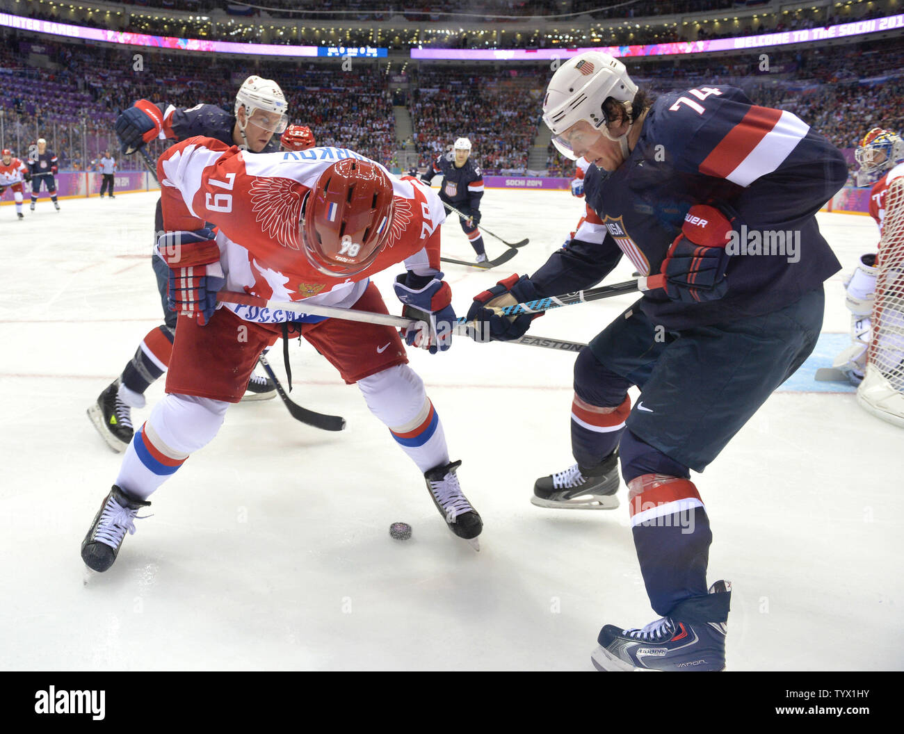 Russia's Andrei Markov frights for the puck with USA's T.J. Oshie in the second period of their preliminary round game at the Sochi 2014 Winter Olympics on February 15, 2014 in Sochi, Russia. UPI/Kevin Dietsch Stock Photo
