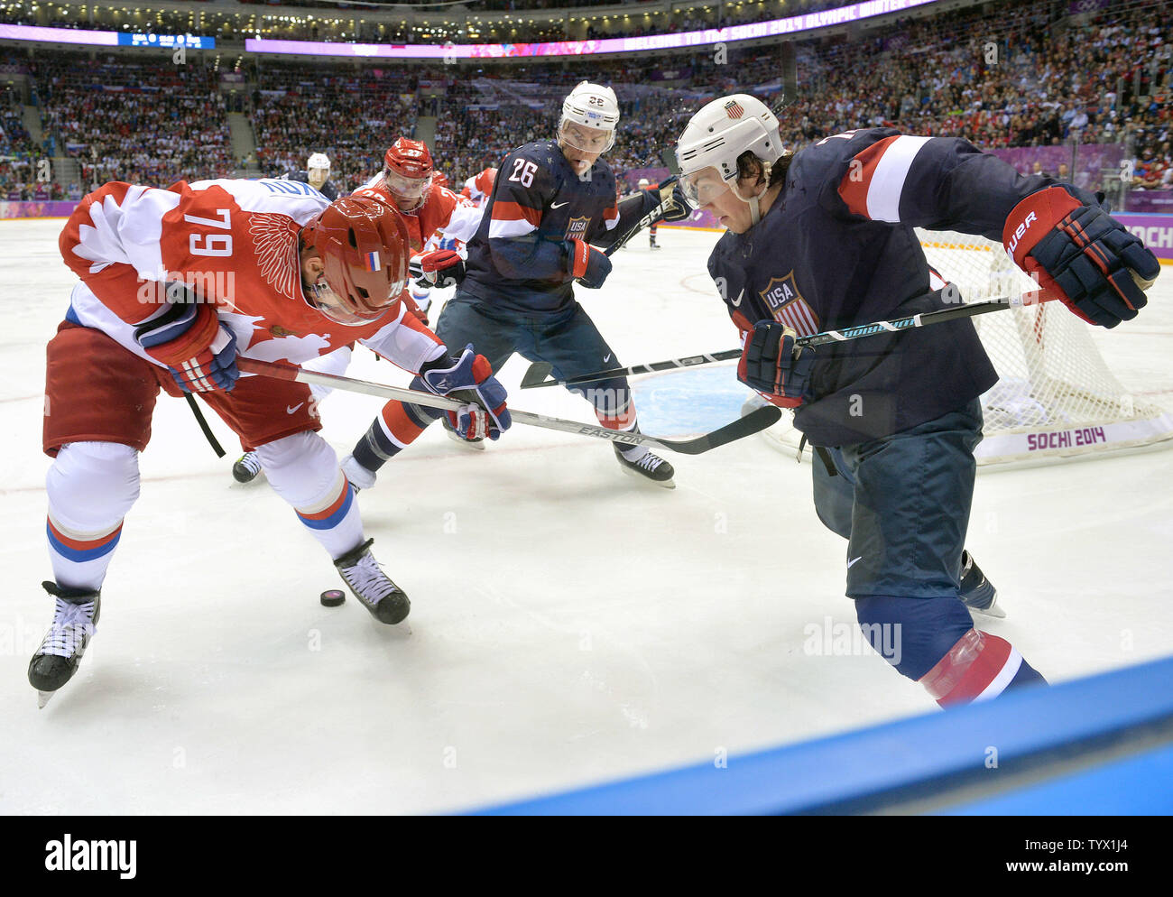 Russia's Andrei Markov frights for the puck with USA's Paul Stastny (26) and T.J. Oshie in the second period of their preliminary round game at the Sochi 2014 Winter Olympics on February 15, 2014 in Sochi, Russia. UPI/Kevin Dietsch Stock Photo