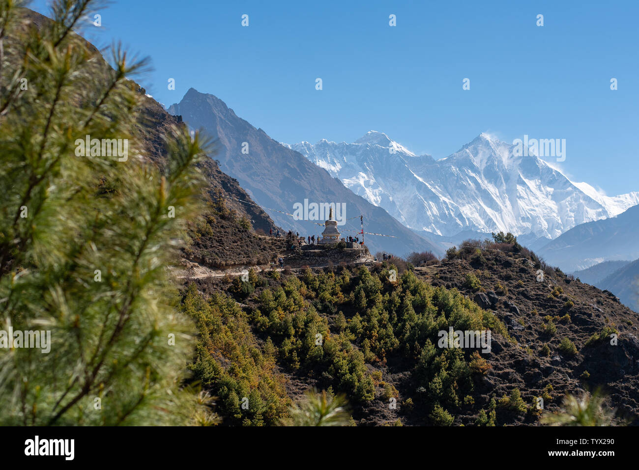 Nepalese Himalayan scenery, tourists around religious monument, Mount Everest and Lhotse in background Stock Photo