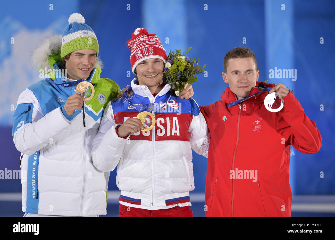 Slovenia's Zan Kosir (L-R), Russia's Vic Wild and Switzerland's Nevin Galmarini celebrate their silver, gold and bronze medals during the victory ceremony for men's snowboard parallel giant slalom at the Sochi 2014 Winter Olympics on February 19, 2014 in Sochi, Russia.      UPI/Brian Kersey Stock Photo