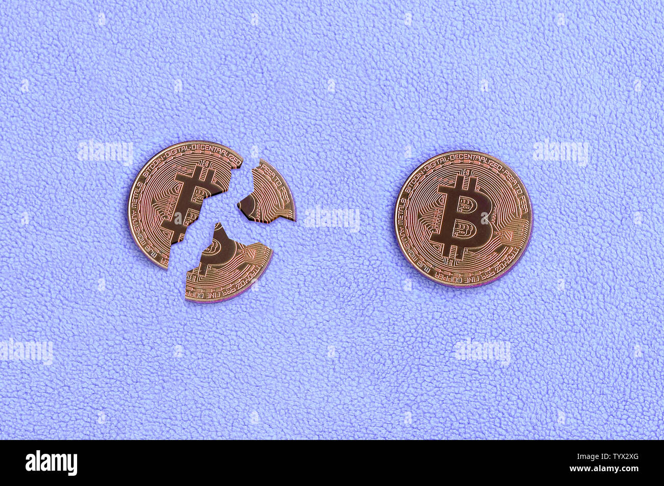 Broken into pieces bitcoin lying on a pink fleece fabric background. The  fall and collapse of the course of crypto currency. Bad news for  cryptocurren Stock Photo - Alamy