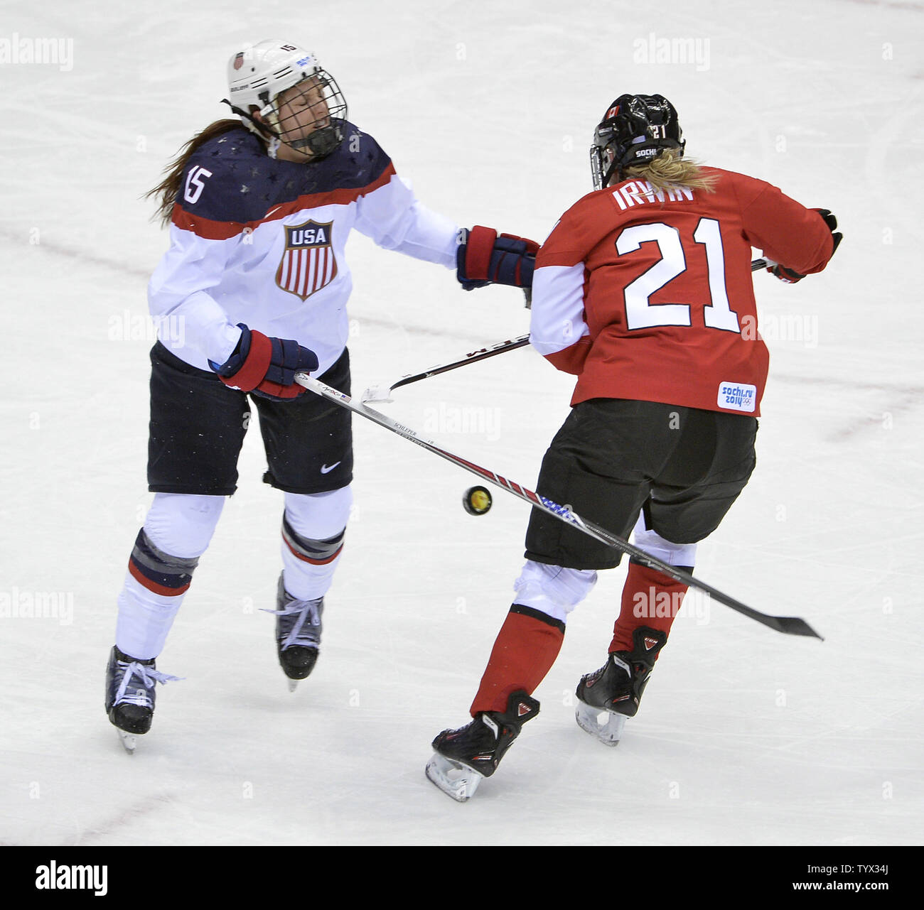 United States' Anne Schleper (L) and Canada's Haley Irwin go for the puck during the first period of the women's gold medal ice hockey game at the Sochi 2014 Winter Olympics on February 20, 2014 in Sochi, Russia.     UPI/Brian Kersey Stock Photo