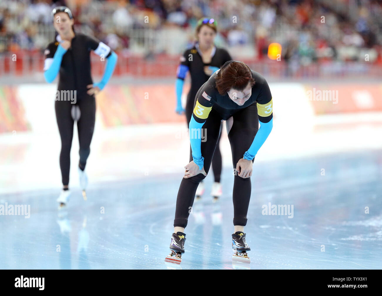 USA's Heather Richardson (front) and teammates, Brittany Bowe (L) and Jilleanne Rookard catch their breath after their race during the speed skating: ladies team pursuit event during the Sochi Winter Olympics on February 22, 2014.  UPI/Maya Vidon-White Stock Photo