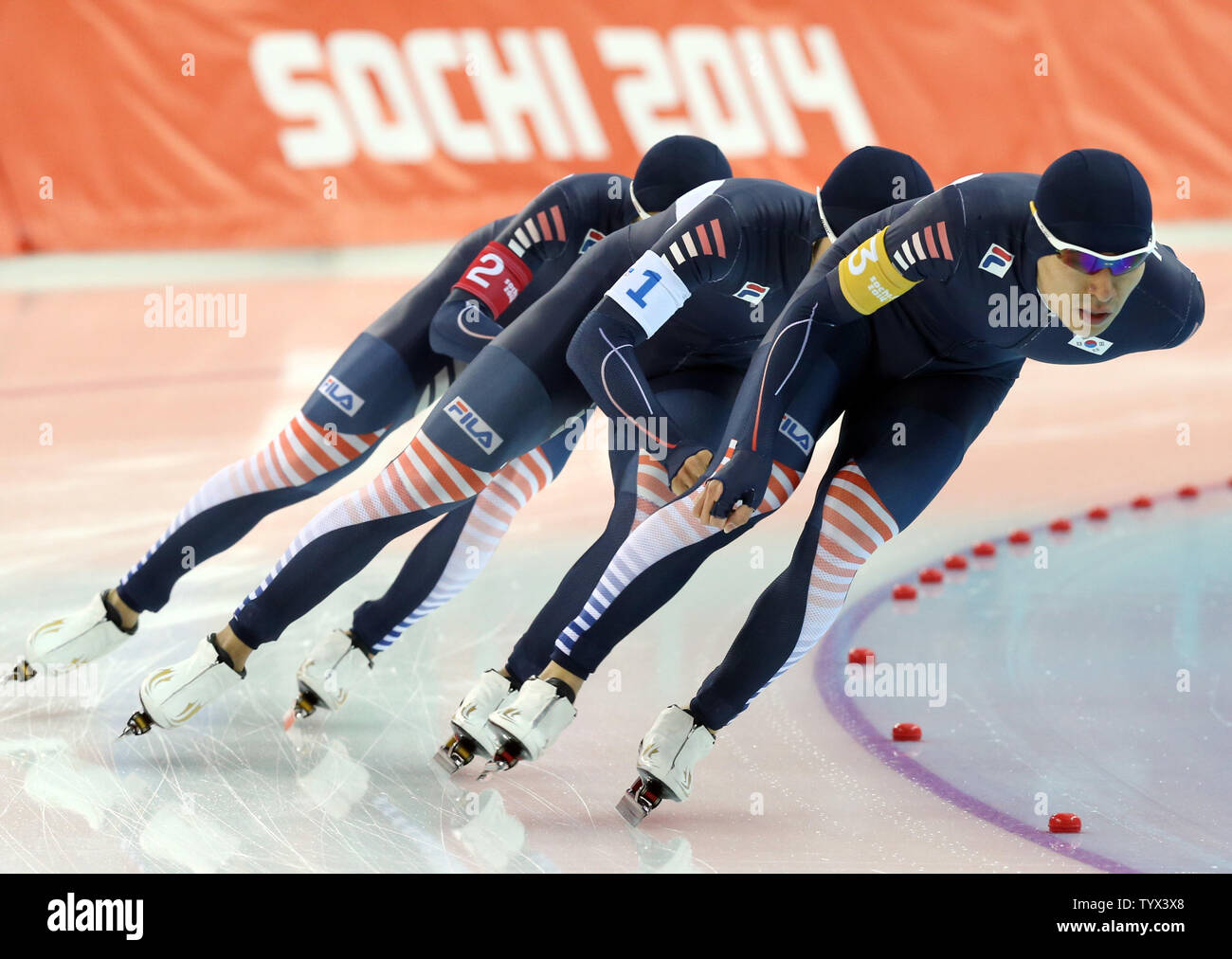 Korea's Lee Seung Hoon leads teammates, Kim Cheol Min and Joo Hyong Jun  (back) as they race to victory during the speed skating: men's team pursuit event during the Sochi Winter Olympics on February 22, 2014. The team won silver. UPI/Maya Vidon-White Stock Photo