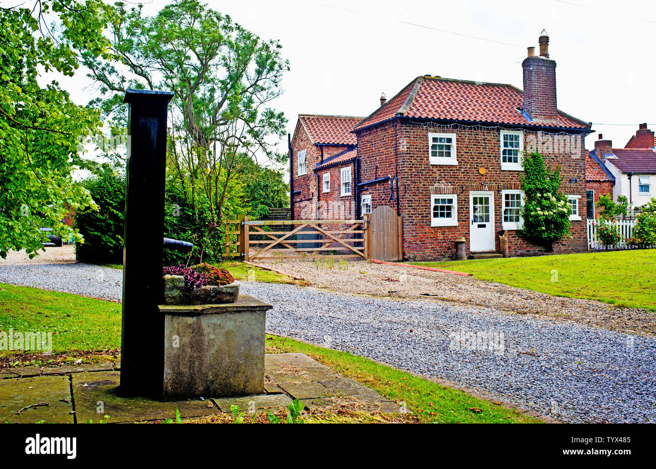 Village Water Pump and Cottage, Hornby, North Yorkshire, England Stock