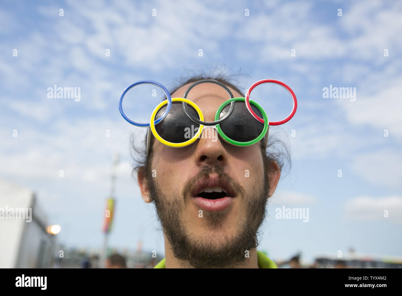 An Olympic volunteer wears Olympic ring sunglasses while guiding members of  the press through a security checkpoint at Olympic Park in Rio de Janeiro,  Brazil on August 4, 2016. The opening ceremonies