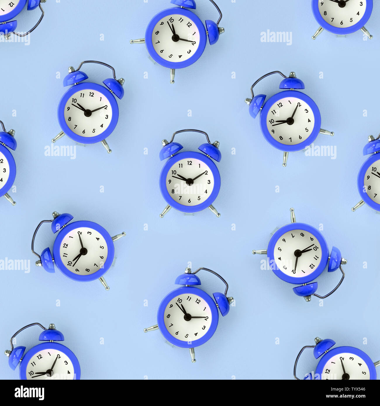 Flat lay retro beautiful new alarm clock on blue color background ...