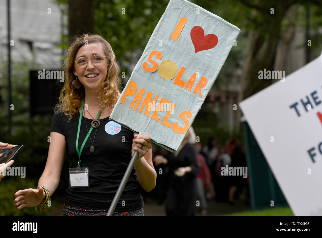 An Environmental protester holds a placard that says I love solar panel during the demonstration.Environmental protesters gathered around Westminster to lobby politicians and tell them that actions need to be done for climate and environment. They also demanded the MP’s to pass new laws to reduce emissions and tackle plastic pollution. Stock Photo