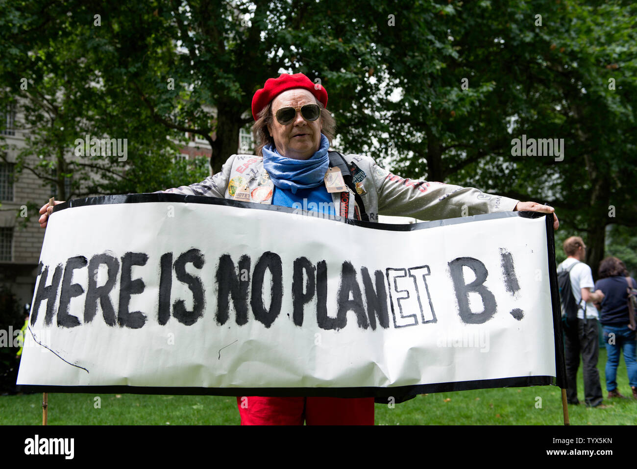An Environmental protester holds a banner that says Here is no planet B during the demonstration.Environmental protesters gathered around Westminster to lobby politicians and tell them that actions need to be done for climate and environment. They also demanded the MP’s to pass new laws to reduce emissions and tackle plastic pollution. Stock Photo