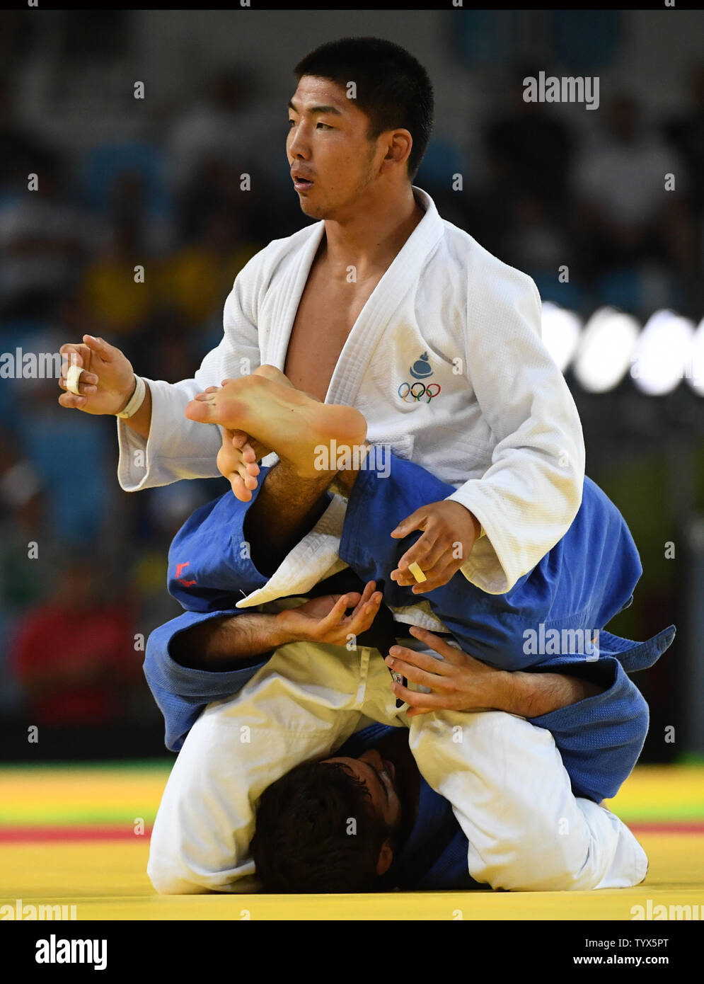 Antoine Bouchard of Canada wraps his legs around Tumurkhuleg Davaadorj of Mongolia in 66KG Judo at the 2016 Rio Summer Olympics in Rio de Janeiro, Brazil, on August 7, 2016. Bouchard won the match.  Photo by Terry Schmitt/UPI Stock Photo