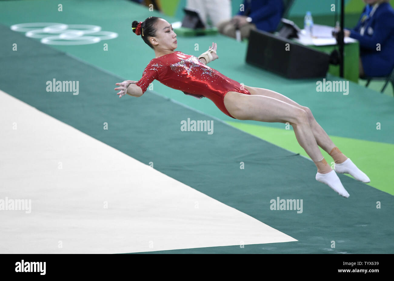 Chinese gymnast Mao Yi lands out of bounds as she competes in the Floor