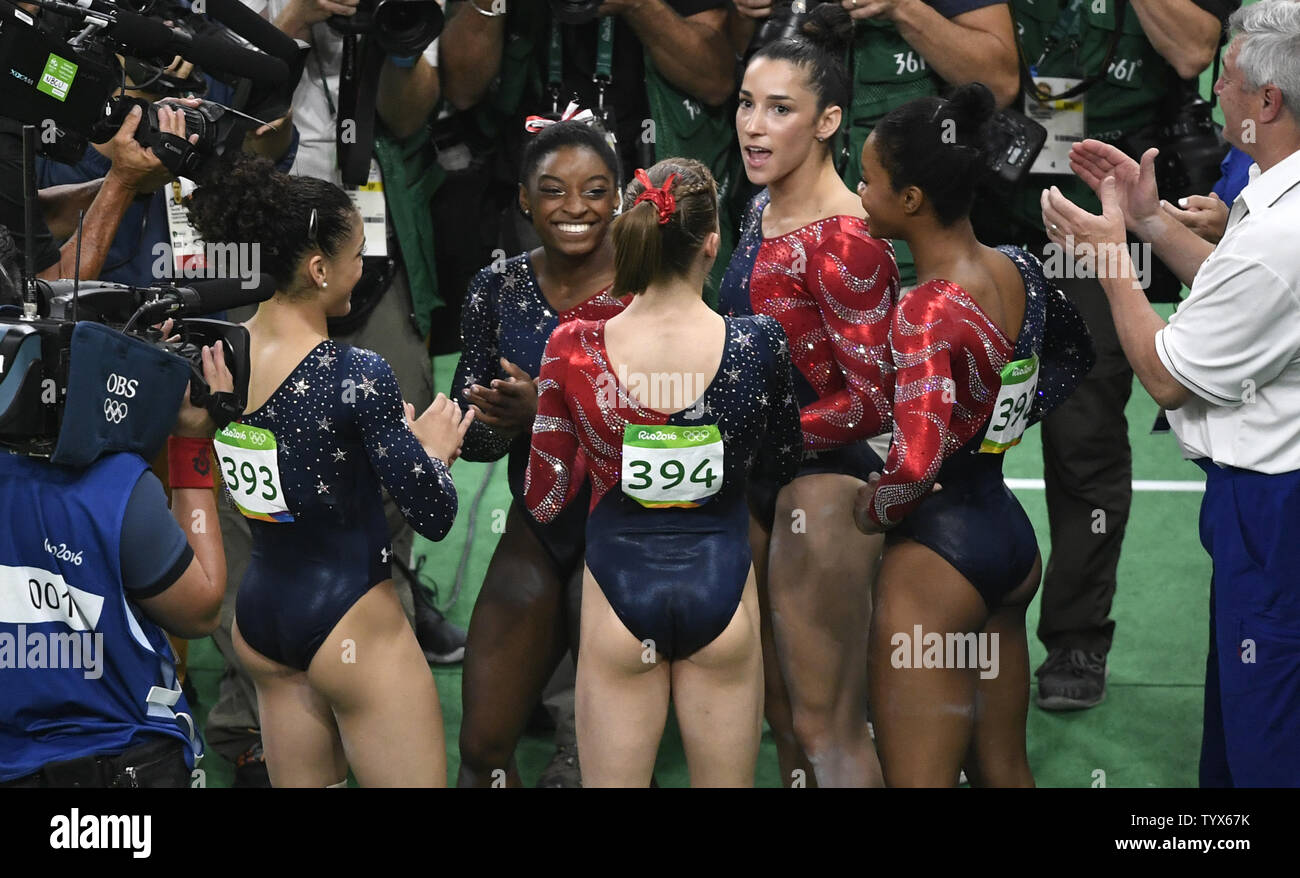 American gymnasts Simone Biles (C) and Aly Raisman (2nd,R) join in  jubilation at the conclusion of their program in the Women's Artistic  Gymnastics qualifications of the 2016 Rio Summer Olympics in Rio