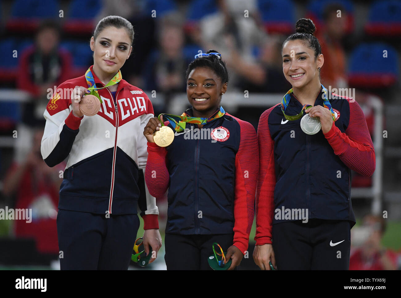 Aliya Mustafina of Russia, Simone Biles and Aly Raisman of the United States stand with their medals at the medal ceremony at the Women's Individual all around in artistic gymnastics at HSBC Arena (Arena Ol’mpica do Rio) at the 2016 Rio Summer Olympics in Rio de Janeiro, Brazil, on August 11, 2016. Simone Biles of the United States won the gold. Photo by Terry Schmitt/UPI Stock Photo