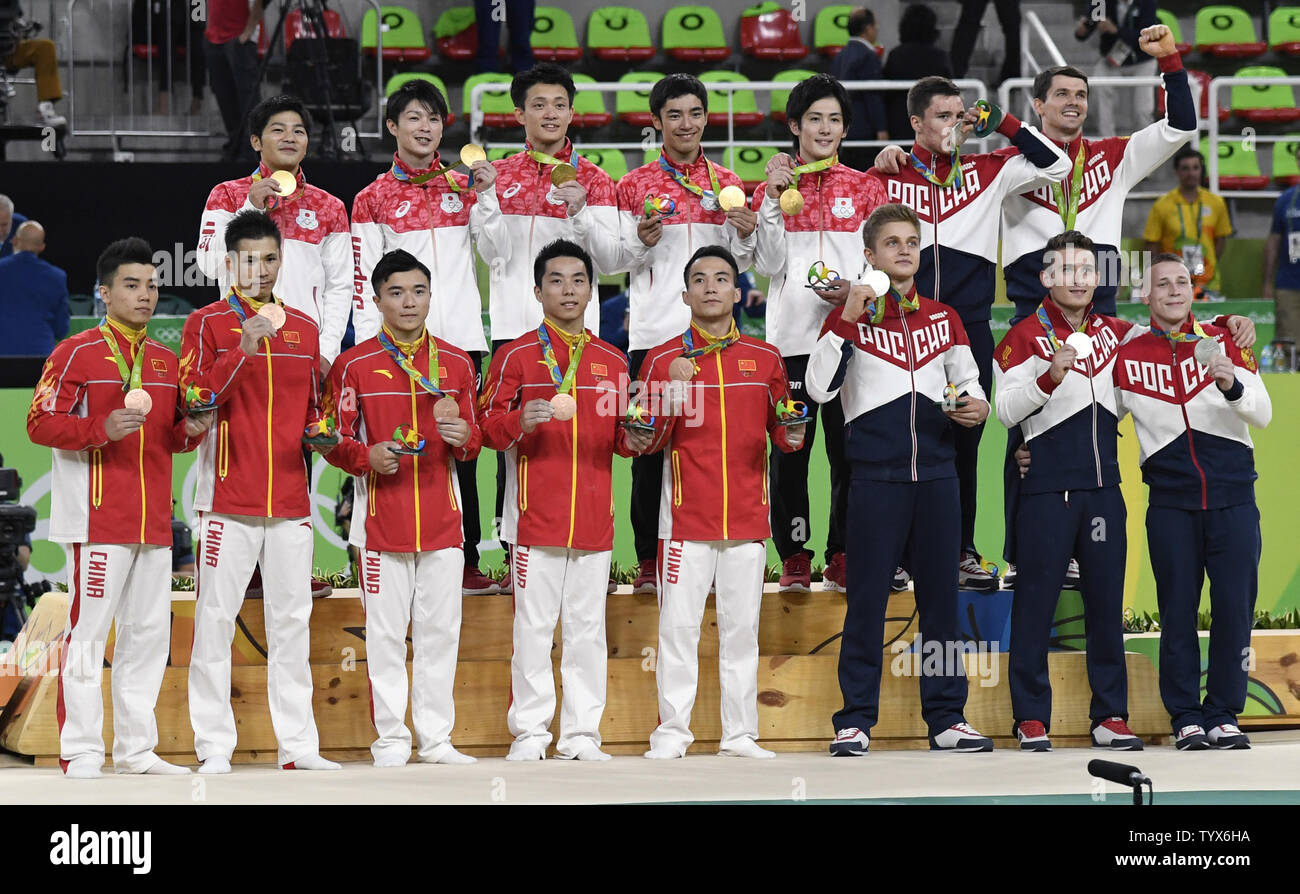 Japan S Gold Medal Winning Team Top L Is Joined By Russia S Silver Medal Winning Team R And China S Bronze Medal Winning Team On The Podium After They Received Their Medals In The Artistic Gymnastics Men S