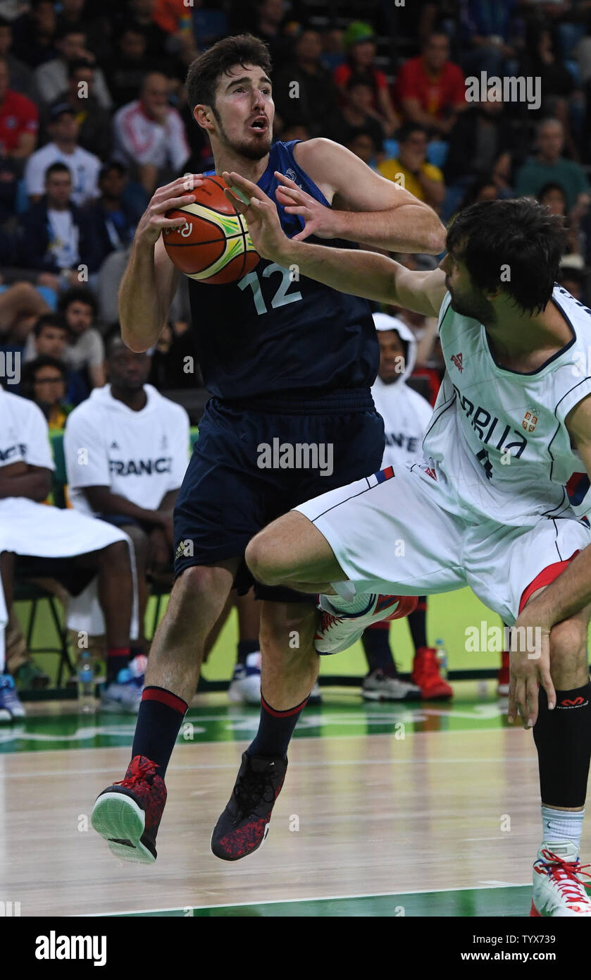 Nando de Colo (12) of France controls the ball against Serbia in Basketball at the 2016 Rio Summer Olympics in Rio de Janeiro, Brazil, August 10, 2016.  France defeated Serbia 76-75 in a come from behind victory in the last minute.  Photo by Terry Schmitt/UPI Stock Photo