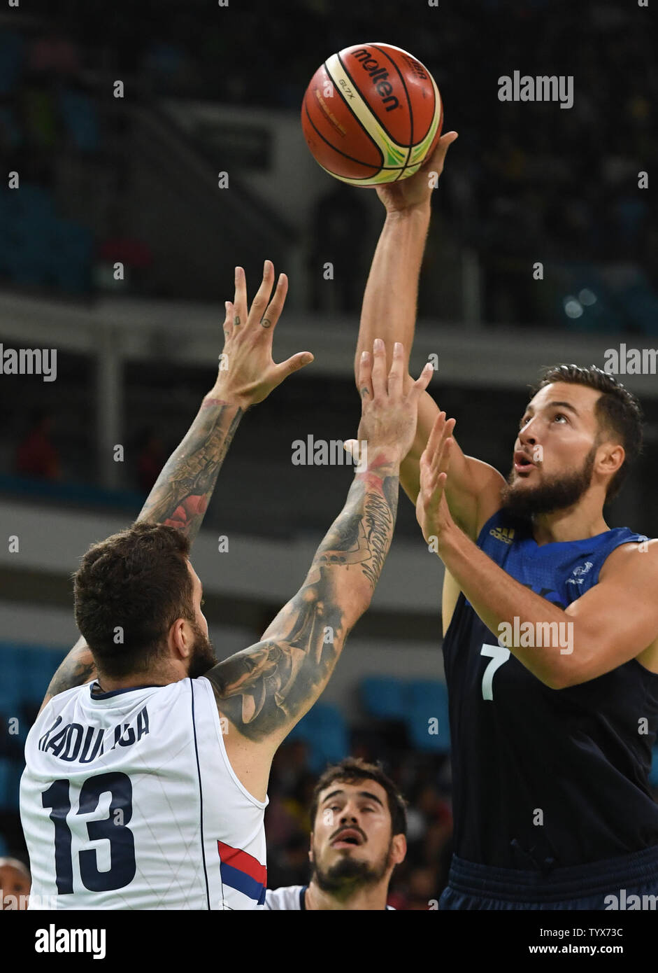 Joffrey Lauvergne (7) of France puts up a shot over Serbia's Miroslav Raduljica (13) in Basketball at the 2016 Rio Summer Olympics in Rio de Janeiro, Brazil, August 10, 2016.  France defeated Serbia 76-75 in a come from behind victory in the last minute.  Photo by Terry Schmitt/UPI Stock Photo