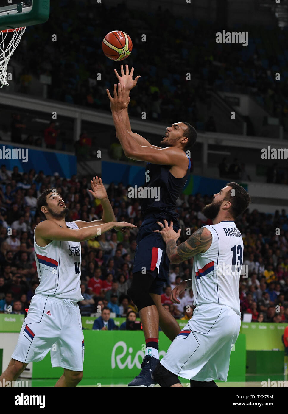 Rudy Gobert (C) of France puts up the ball between Serbia's Miroslav Raduljica (13) and Nikola Kalinin (10) in Basketball at the 2016 Rio Summer Olympics in Rio de Janeiro, Brazil, August 10, 2016.  France defeated Serbia 76-75 in a come from behind victory in the last minute.  Photo by Terry Schmitt/UPI Stock Photo