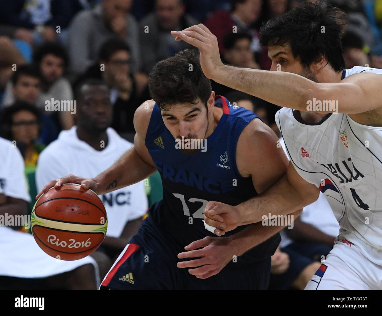 Thomas Heurtel (4) of France drives on Serbia's Milos Geodesic (R) in Basketball at the 2016 Rio Summer Olympics in Rio de Janeiro, Brazil, August 10, 2016.  France defeated Serbia 76-75 in a come from behind victory in the last minute.  Photo by Terry Schmitt/UPI Stock Photo