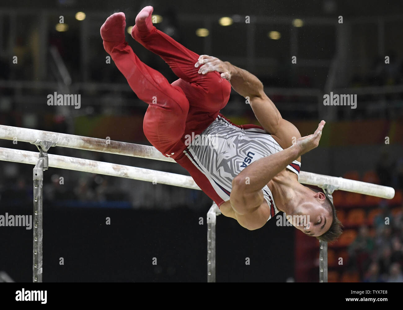 American gymnast Samuel Mikulak dismounts after his routine on the Parallel Bars in the Men's