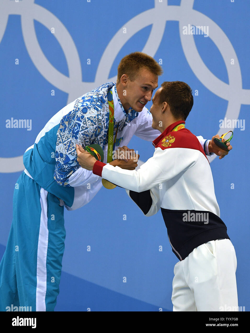 Gold Medal Winner Dmitriy Balandin Of Kazakhstan L Is Embraced On The Medal Stand By Ilya Khomenko Of Russia Who Placed Silver In The Men S 200m Breaststroke Finals At The Olympic Aquatics