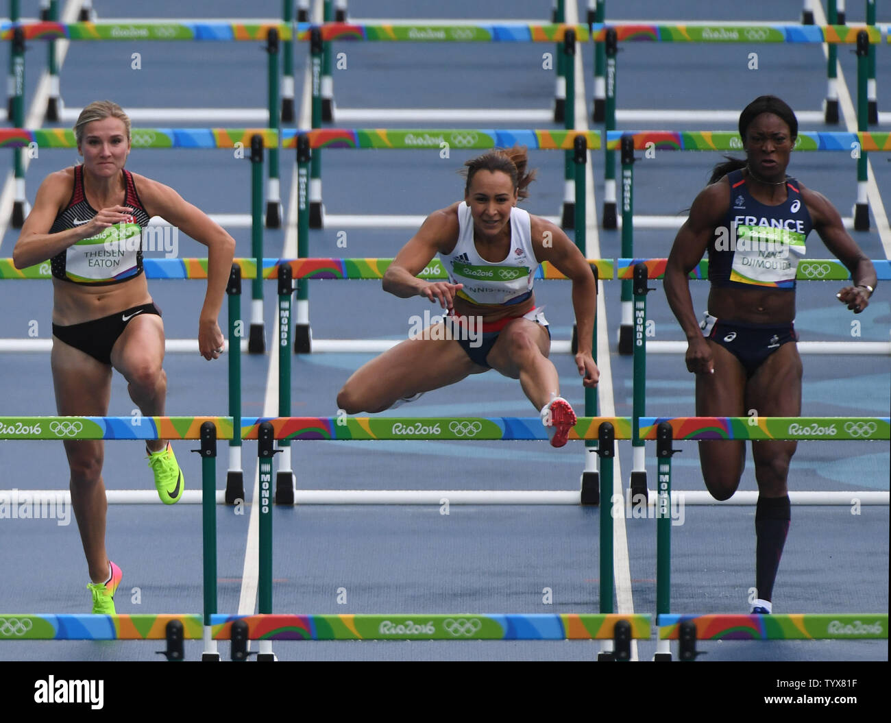 Jessica Ennis-Hill (C) takes a hurdle between Brianne Theisen Eaton of Canada(L) and Antoinette Nana Djimou Ida of France in a  heat of the Women's Heptathlon 100M Hurdles with WSA's Heather Miller-Koch at right is run in the Olympic Stadium at the 2016 Rio Summer Olympics in Rio de Janeiro, Brazil, August 12, 2016.  Ennis-Hill won the gold medal in London 2012 Olympics.    Photo by Terry Schmitt/UPI Stock Photo